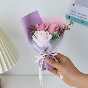 Detail of mini soap rose bouquet with purple and pink wrapping and a satin bow