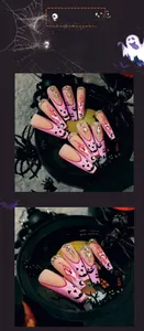 Detail of pink French press-on nails with black pumpkin face and rhinestone accents