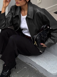 Chic women's black faux leather jacket for casual autumn wear styled outdoors
