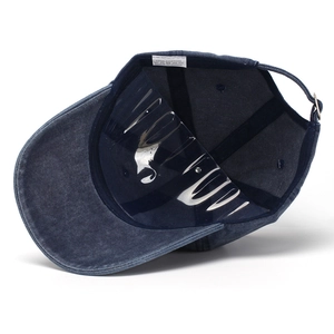 Washed cotton baseball cap in navy blue with distressed brim and adjustable metal strap