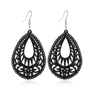 Detail of black hollow teardrop wooden earrings with silver fishhook ear wires