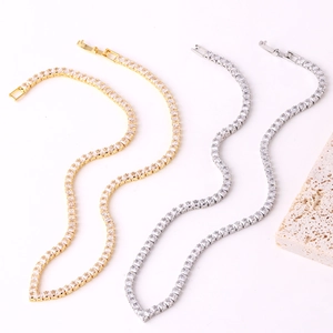 Detail of gold and silver V-shaped tennis bracelets with cubic zirconia on stones