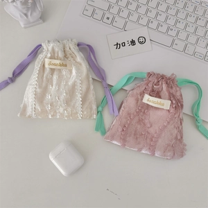Detailed macro shot of lace trim velvet drawstring bags with contrasting color cords