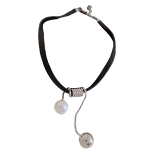 Minimalist black cord necklace featuring asymmetrical silver beads and white pearl pendant