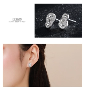 Detailed macro view and model shot of silver geometric earrings with micro-inlaid zircons