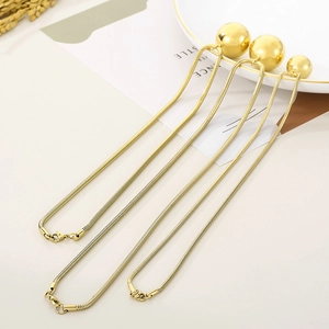 Golden snake chain necklaces with polished round sphere pendants for women in minimalist style