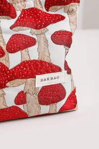 Close-up of vintage mushroom jacquard fabric cosmetic bag with H&R BAG logo label