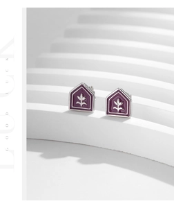 Detail of purple enamel tulip earrings with silver flower relief and geometric shape