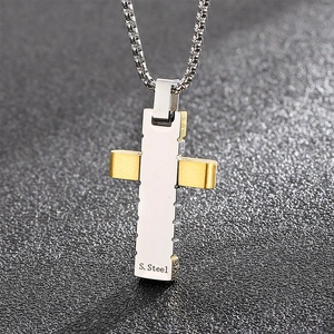 Collier avec pendentif croix en acier inoxydable bicolore argent et or sur fond texturé