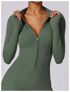 Detail of olive green athletic jumpsuit with front zipper and functional thumbholes