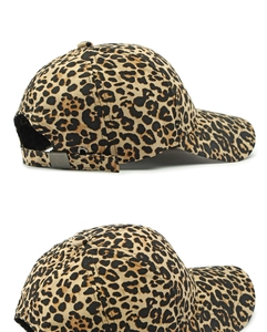 Detail of leopard print baseball cap featuring adjustable metal buckle and canvas texture