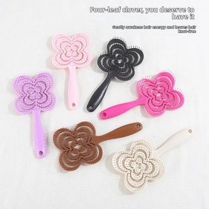 Detail view of ventilated hairbrushes in six vibrant colors with clover-shaped patterns