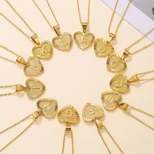Gold heart initial pendant necklaces with A-L letter engraving and radial texture