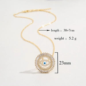 Detail of gold evil eye pendant with blue center and clear zircons, 23mm diameter size
