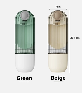 Close-up of portable green and beige travel storage bottles with 21.5cm height markers