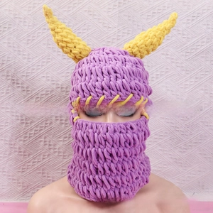 Detail of chunky knit purple balaclava with yellow monster horns for Halloween party