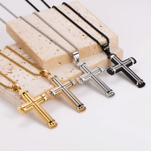 Three-color geometric stainless steel cross necklaces in gold, silver, and black on stone