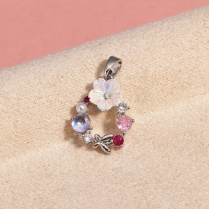 Detailed view of floral zircon pendant with pink stones and a small butterfly charm