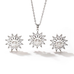 Luxurious silver necklace and earrings set with white pearls and sparkling zircons