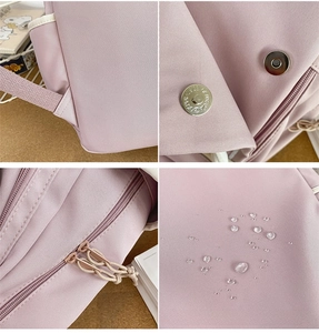 Detail view of pink backpack showing waterproof nylon fabric and durable metal hardware