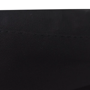 Close-up of black knitted fabric with fine flat stitching on military beret hat