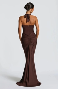 Detailed back view of a brown halter evening gown with ruched waist and backless design