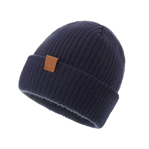 Detailed view of dark blue chunky knit beanie showing soft texture and leather patch