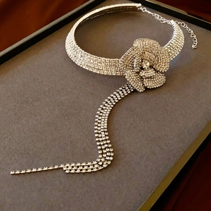 Detail shot of camellia floral choker with sparkling rhinestone tassel and silver finish