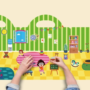 Close-up of child hands placing reusable stickers on a colorful indoor scene board