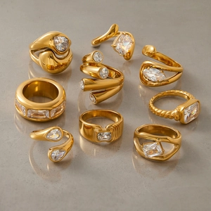 Collection of luxury 18K gold plated titanium steel rings with clear zircon stones