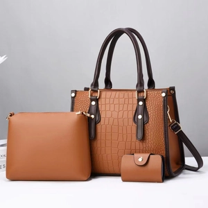 Brown crocodile embossed three-piece handbag set featuring a tote and clutch bags