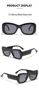 Detail view of bold black square frame sunglasses with grey lenses and temple inscriptions