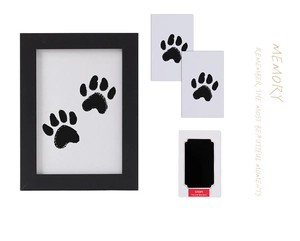 Detail of pet paw print keepsake kit including black frame, inkless pad, and cards