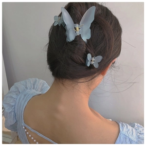 Matte ice blue butterfly hair clips set on hair showing elegant resin styling