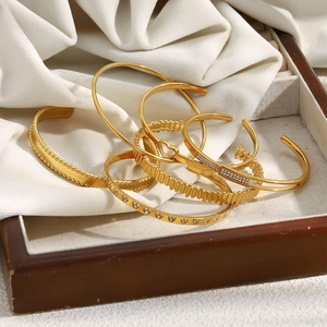 Detailed view of 18K gold plated hollow heart bangles set with sparkling zircon stones