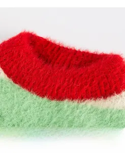 Close-up of vibrant red and green knitted pet sweater with soft mohair texture