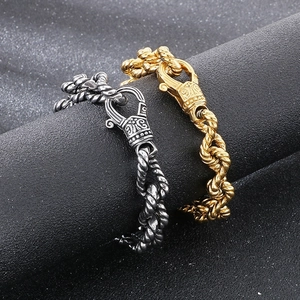 Detail of vintage punk twisted chain bracelets in silver and gold with ornate clasps