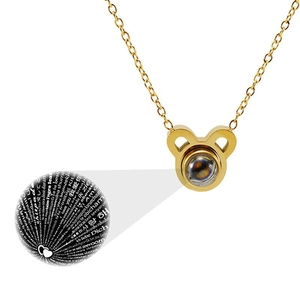 Detail showing 'I love you' projection in 100 languages inside a golden zodiac pendant