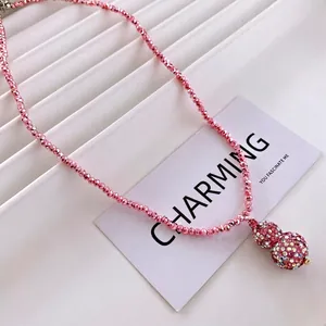 Pink beaded necklace featuring a sparkling crystal-encrusted gourd pendant for women