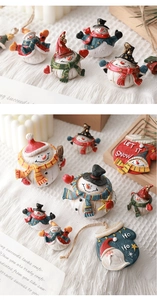 Detailed view of miniature resin snowmen and Santa ornaments on cozy holiday decor