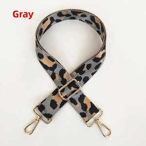 Detail of adjustable leopard print bag strap in grey with gold metal swivel hooks