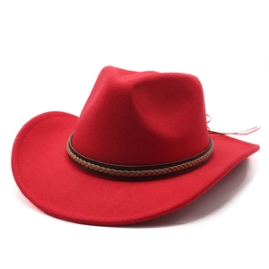 Detail of red wool felt cowboy hat with brown braided leather band and curved brim
