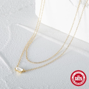 Macro shot of S925 sterling silver gold necklace featuring a rectangular zircon pendant