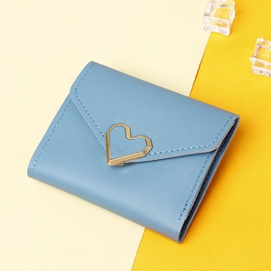 Detail view of a blue leather tri-fold wallet featuring a gold heart-shaped metal buckle