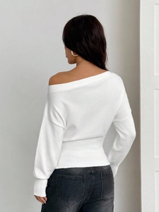 Vue arrière détaillée du pull en maille blanc à épaules dénudées et texture fine