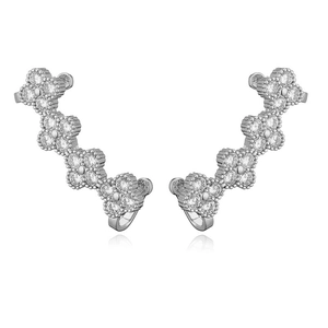 Macro shot of clover-shaped crawler earrings with sparkling zircon crystals