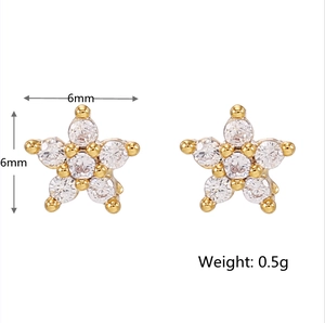 Detail view of 6mm star shaped 18K gold earrings with white zircon stones and 0.5g weight