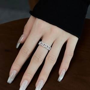 Elegant S925 sterling silver chain ring with pavé-set zircons worn on finger