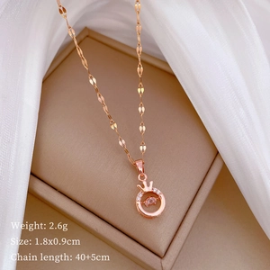 Detail view of rose gold crown pendant with sparkling crystals and size specifications