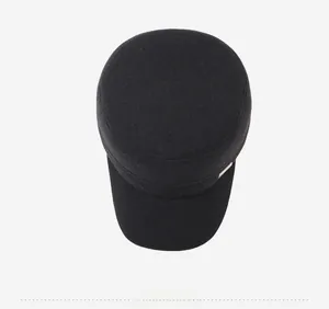 Top view of a black flat top military cap for elderly men with warm wool blend fabric